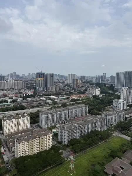 Exterior type: high-rise condominium; features: city skyline view, multiple high-rise buildings, green landscaping, urban residential area, commercial buildings in distance, open space with grass, power lines visible; style: modern.