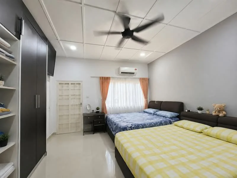 Bedroom features: two beds with blue bedding, yellow checkered bedding on one bed, upholstered headboard, ceiling fan, wall-mounted air conditioning unit, floor-to-ceiling window with sheer curtains, built-in wardrobe with sliding doors, nightstand with lamp, decorative teddy bear, light-colored tiled flooring, grey painted walls, orange curtain drapes; style: modern.