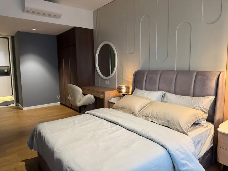 Bedroom features: king-size bed with upholstered headboard, bedding in light grey, wooden flooring, decorative wall with wavy design, round wall mirror, study desk with chair, built-in wardrobe, table lamp, wall-mounted air conditioning unit, soft lighting, neutral color palette; style: modern.