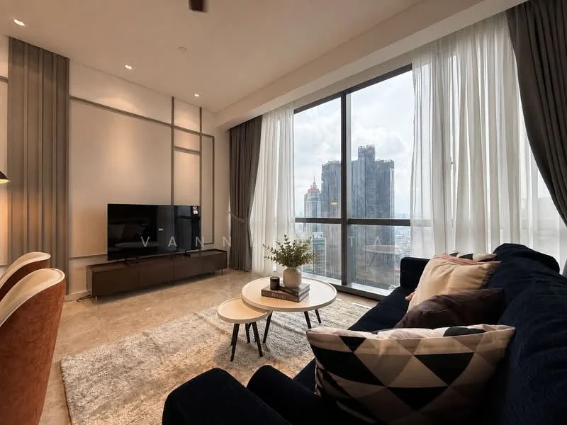 Living features: floor-to-ceiling windows, grey fabric sofa, coffee table, TV console, wall-mounted TV, area rug with geometric pattern, decorative plants, curtains, light fixtures, neutral wall colour, concrete flooring, accent pillows; style: modern; view: city.