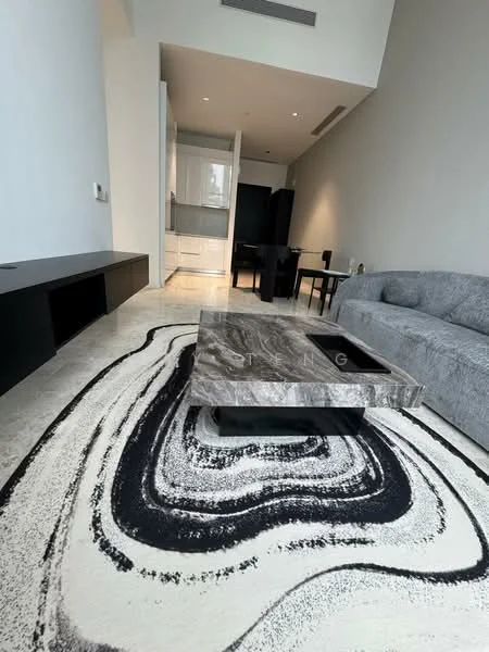 Living features: grey fabric sofa, marble coffee table, area rug with abstract pattern, wall-mounted TV console, recessed downlights, light-coloured walls, polished stone flooring, open layout, dining area visible in background; style: modern.