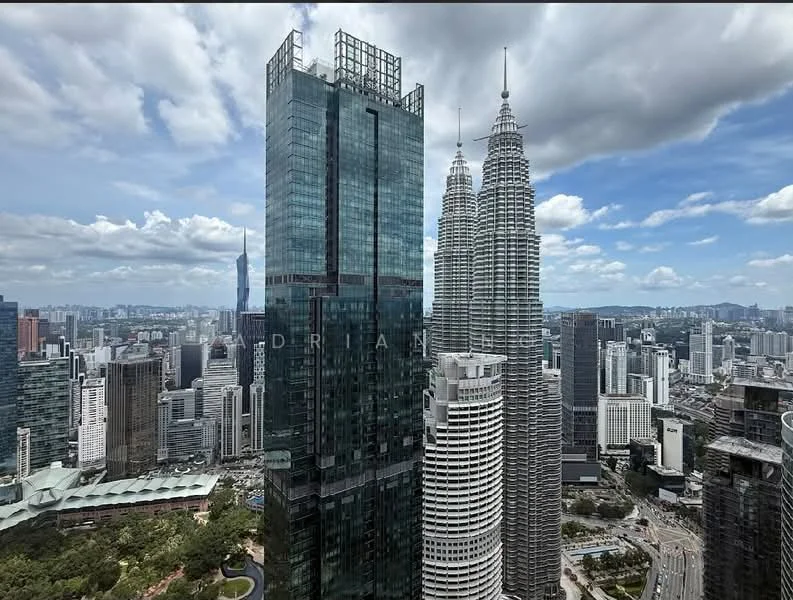 Exterior type: high-rise condominium; features: glass curtain wall, approximately 50-storey high-rise, surrounded by city skyline, view of Petronas Twin Towers, modern architectural design, landscaped area at base, urban context with high-density buildings; style: modern.