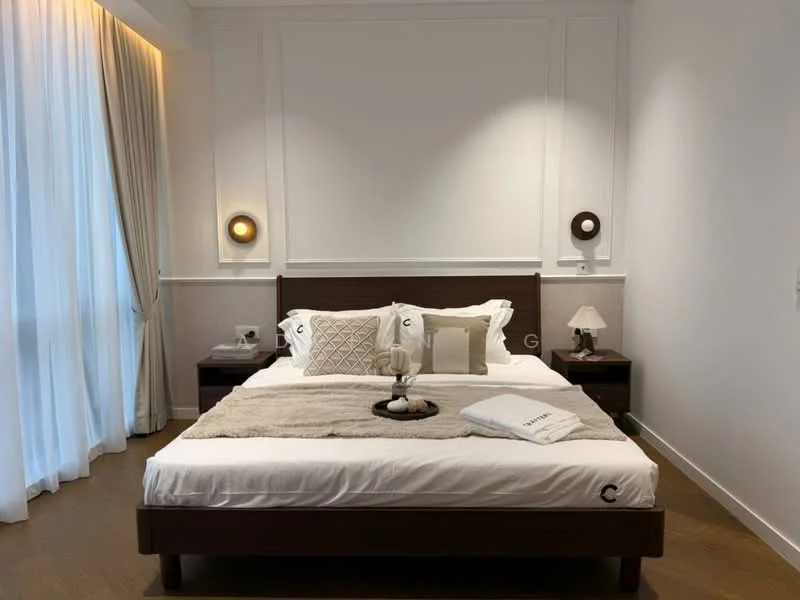 Bedroom features: king-size bed with white bedding, upholstered headboard, two bedside tables with lamps, decorative throw pillows, plush throw blanket, wooden flooring, floor-to-ceiling windows with sheer curtains, wall-mounted sconces, white painted walls, crown moulding; style: modern.