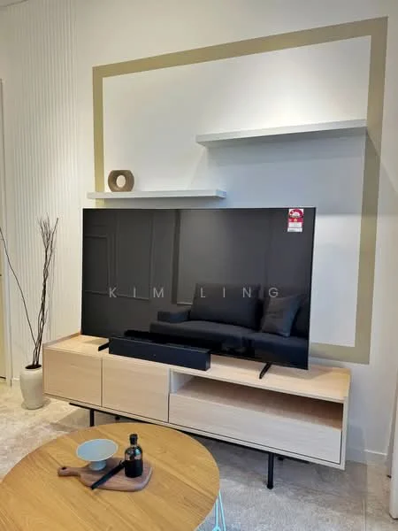 Living features: wall-mounted TV, light wood TV console, black soundbar, decorative shelf above TV, neutral wall color, decorative wall frame, round coffee table, ceramic bowl on coffee table, glass bottle on coffee table, tall decorative branch in vase, carpeted flooring; style: modern.