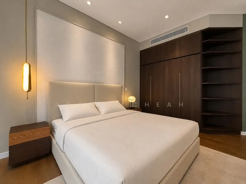 Bedroom features: king-size bed with upholstered headboard, light beige bedding, wooden bedside table, table lamp with round shade, built-in wardrobe with sliding doors, open shelving unit, neutral wall color, recessed ceiling lights, wooden flooring, area rug; style: modern.