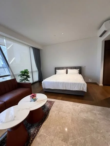 Bedroom features: king-size bed with white bedding, upholstered headboard, 2 bedside tables, table lamps on bedside tables, large window with sheer curtains, wooden flooring, recessed ceiling lights, air conditioning unit, decorative plant in ceramic pot, 2-seater leather sofa in brown, marble coffee table, area rug with geometric pattern; style: modern; view: city.