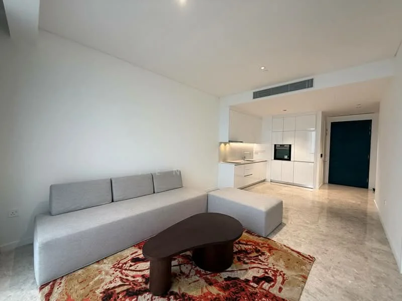 Living features: L-shape sectional sofa in light grey fabric, coffee table in dark wood, area rug with abstract pattern in red and beige, white painted walls, marble flooring, recessed downlights, built-in kitchen cabinetry in white, integrated kitchen appliances, open layout, floor-to-ceiling windows, neutral color palette; style: modern.