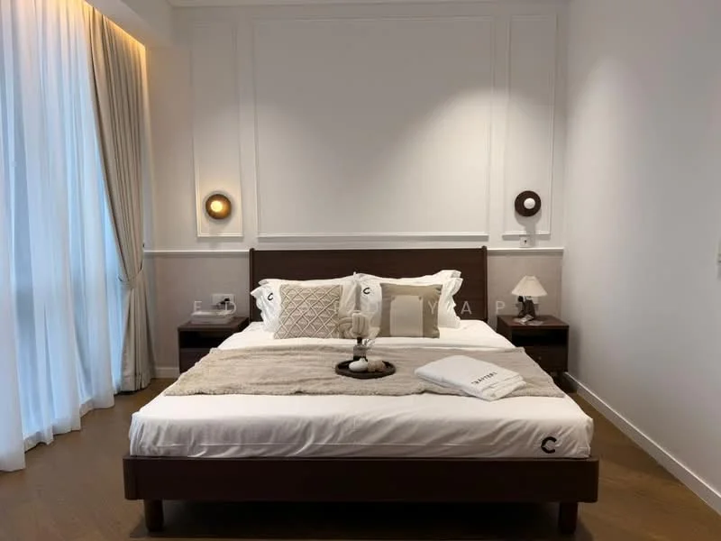 Bedroom features: king-size bed, upholstered headboard, white bedding, decorative throw pillows, nightstands on either side, table lamps on nightstands, wooden flooring, white painted walls, recessed lighting, sheer curtains, decorative wall paneling; style: modern.