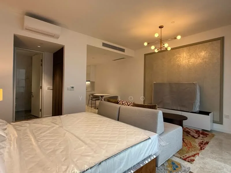 Living features: queen-size bed, sofa with grey upholstery, coffee table, area rug with geometric pattern, chandelier with multiple bulbs, wall-mounted TV, built-in cabinetry, marble flooring, air conditioning unit, decorative wall panel, dining table for four, open layout; style: modern. Room features: white painted walls, doorway leading to bathroom, kitchen area visible.