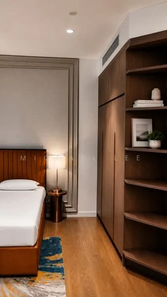 Bedroom features: queen-size bed, wooden bed frame, nightstand with lamp, built-in wardrobe, open shelving unit, wooden flooring, grey painted walls, decorative wall paneling, area rug with geometric pattern, recessed ceiling lights; style: modern.