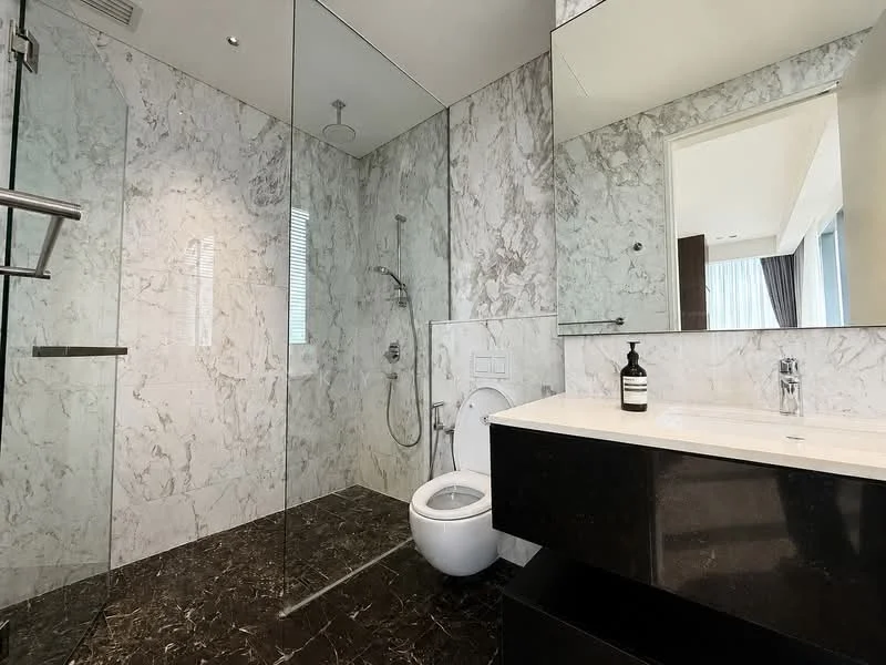 Bathroom features: marble wall cladding, glass shower enclosure, rain shower head, handheld shower, wall-mounted shower controls, black marble flooring, floating vanity with black countertop, single-sink vanity, one-piece toilet, framed mirror, recessed ceiling lights; style: modern.