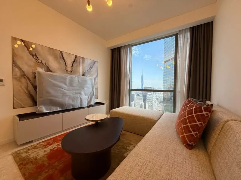 Living features: large floor-to-ceiling windows, city skyline view, light-colored fabric sofa, decorative throw pillows, modern coffee table, abstract wall art, TV mounted on wall, white cabinetry, recessed ceiling lights, neutral-colored walls, area rug with geometric pattern; style: modern; view: city.