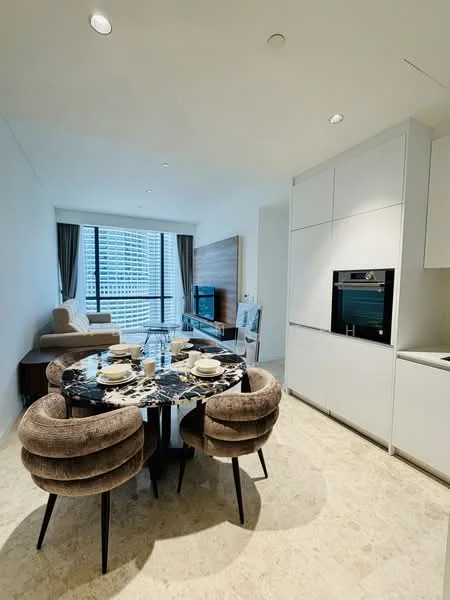 Dining features: round marble dining table, 4 upholstered dining chairs in grey, floor-to-ceiling windows, curtains, recessed downlights, light-coloured walls, cream tile flooring, built-in cabinetry, built-in oven, TV console, sofa in beige, wood panel accent wall; style: modern; view: city.
