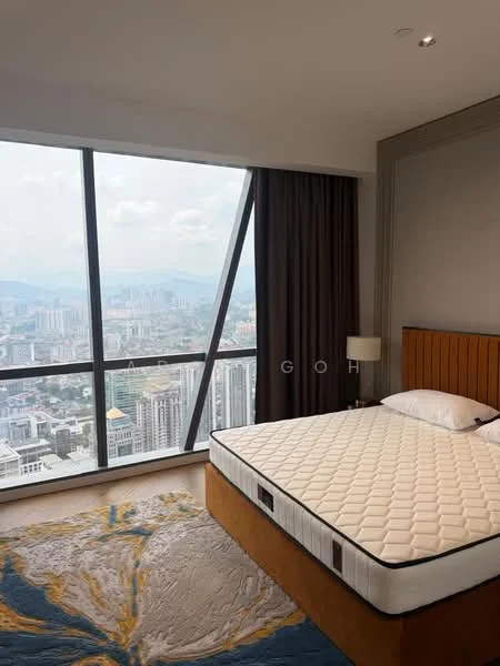Bedroom features: king-size bed, upholstered headboard, floor-to-ceiling windows, city view, grey curtains, area rug with abstract pattern, nightstand with lamp, decorative wall paneling; style: modern; view: city.