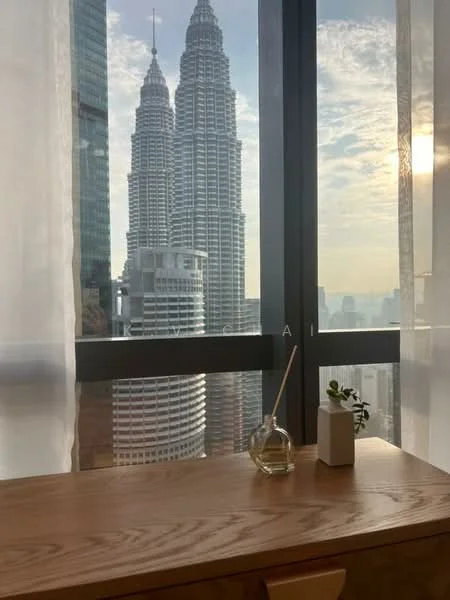Room features: floor-to-ceiling windows, wooden desk, decorative plant, glass diffuser, sheer curtains, city skyline view; style: modern; view: city.
