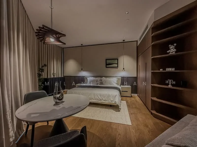 Bedroom features: king-size bed with white bedding, wooden headboard, nightstands on either side of the bed, pendant lighting above the nightstands, built-in wardrobe with sliding doors, wooden flooring, area rug under the bed, floor-to-ceiling curtains, decorative wall art, small round dining table, grey upholstered chairs, shelf unit with decorative items; style: modern.