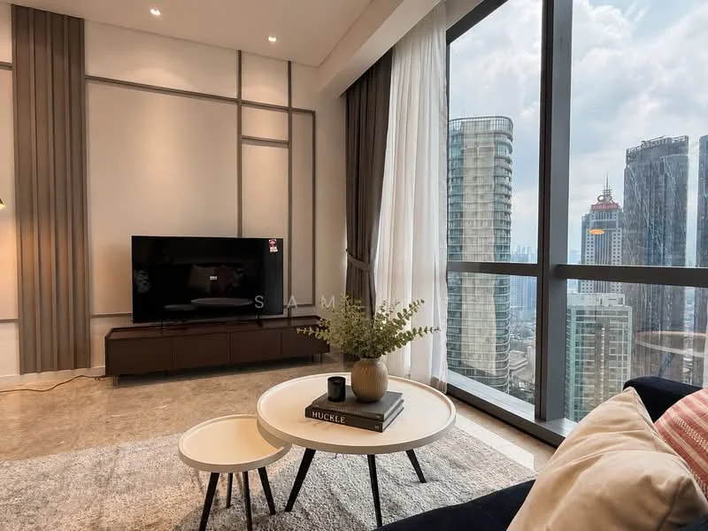 Living features: floor-to-ceiling windows, grey accent wall, light-colored walls, recessed downlights, sofa with cushions, coffee table with books, TV console, wall-mounted TV, area rug, decorative plant, curtains, city skyline view; style: modern; view: city.