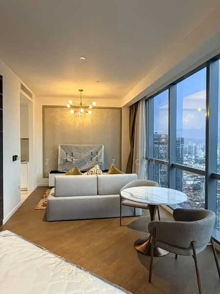Living features: floor-to-ceiling windows, grey fabric sofa, round marble-top coffee table, chandelier with multiple bulbs, decorative wall with textured finish, area rug with geometric pattern, city skyline view, wooden flooring; style: modern; view: city. Room features: white walls, recessed downlights, curtains.