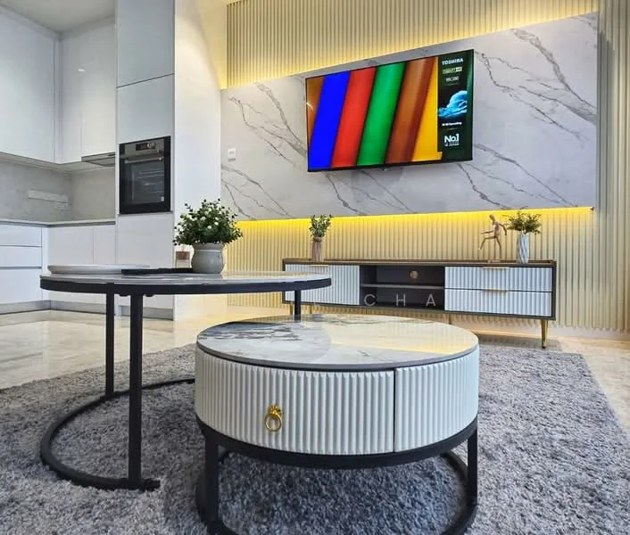 Living features: white cabinetry with marble countertop, built-in oven, recessed LED downlights, wall-mounted TV, coffee table with marble top, round coffee table with black base, grey area rug, decorative plants in pots, feature wall with vertical slats, lighted wall panel, sofa not visible; style: modern.