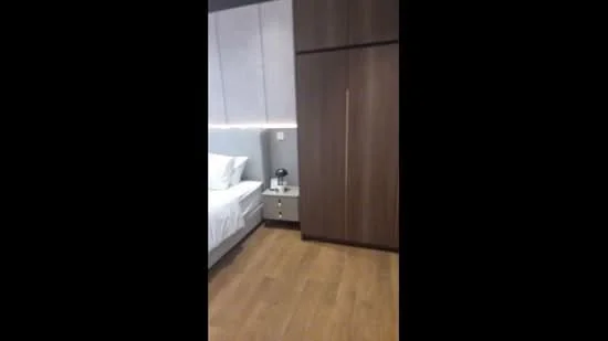 Bedroom features: queen-size bed with white bedding, wooden flooring, built-in wardrobe with wooden finish, nightstand with lamp, grey accent wall, recessed lighting, white painted walls, decorative wall paneling; style: modern.