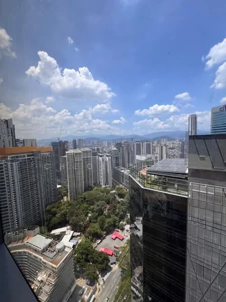 Exterior type: high-rise condominium; features: city skyline view, surrounded by urban landscape, visible greenery, multiple high-rise buildings, clear blue sky, clouds, glass facade, rooftop gardens; style: modern.