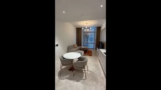 Living features: round dining table, 3 upholstered dining chairs, sofa in beige fabric, area rug, floor-to-ceiling windows, curtains, recessed downlights, light fixture with multiple bulbs, neutral painted walls, marble flooring; style: modern; view: city.