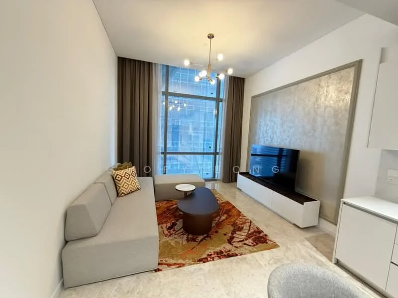 Living features: grey fabric L-shape sectional sofa, round coffee table, TV console with wall-mounted TV, decorative area rug with geometric pattern, chandelier with multiple bulbs, floor-to-ceiling windows, curtains, marble flooring, accent wall with textured finish; style: modern; view: city.