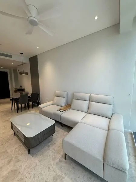 Living features: L-shape sectional sofa in light grey fabric, coffee table with a glass top and dark base, ceiling fan with light, recessed downlights, cream marble flooring, neutral painted walls, dining area visible in background, open layout, large windows allowing natural light; style: modern.