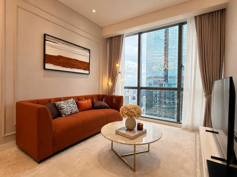 Living features: orange fabric sofa, round glass coffee table, TV console, wall-mounted TV, floor-to-ceiling windows, sheer curtains, decorative vase with flowers, area rug, modern artwork on wall, recessed downlights; style: modern; view: city.