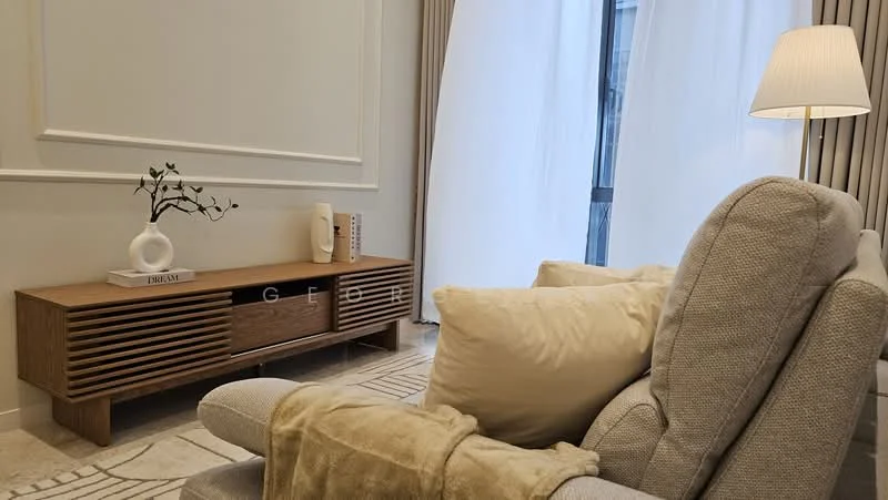 Living features: beige fabric sofa, wooden TV console with slatted design, decorative vase on console, soft throw pillows, floor lamp with white shade, light-colored curtains, neutral wall color, textured area rug, marble flooring; style: modern.