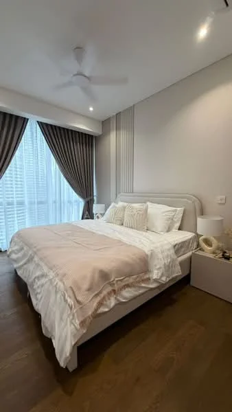 Bedroom features: king-size bed with upholstered headboard, white bedding with decorative pillows, nightstand with lamp, floor-to-ceiling windows with sheer curtains, dark wood flooring, ceiling fan, wall-mounted decor, accent wall with vertical paneling; style: modern.