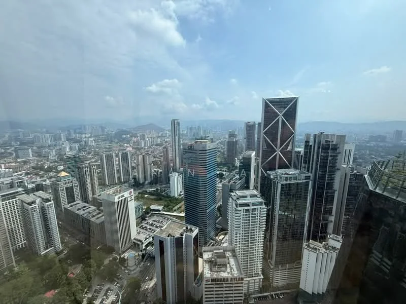 Exterior type: high-rise condominium; features: city skyline view, glass curtain wall, modern architectural design, surrounded by urban landscape, multiple high-rise buildings, clear blue sky, distant mountains, visible rooftops of nearby buildings; style: modern.