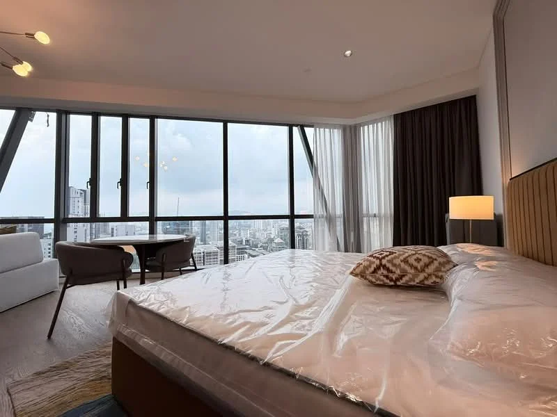 Bedroom features: king-size bed with upholstered headboard, floor-to-ceiling windows, sheer curtains, wooden flooring, recessed downlights, decorative throw pillow, side table with lamp, armchair, small dining table, city view; style: modern; view: city.