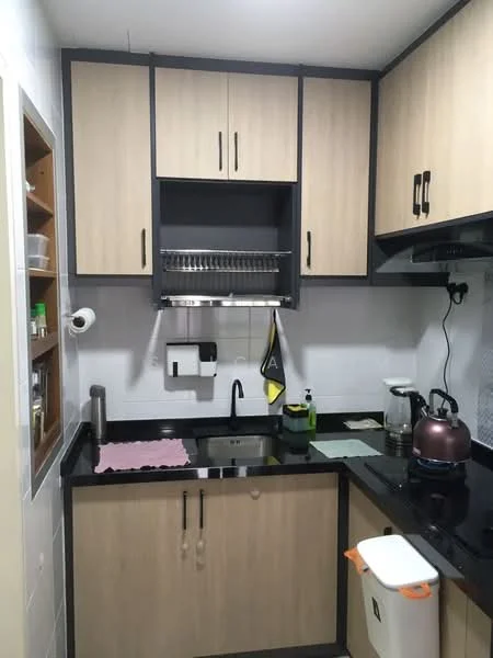 Kitchen features: black granite countertop, wood cabinetry with light wood finish, black handles on cabinets, stainless-steel sink, chrome pull-down faucet, built-in dish rack above sink, kettle on countertop, coffee maker on countertop, wall-mounted paper towel holder, white tiled backsplash, open shelving for storage, waste bin under counter; style: modern.