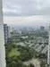 Exterior type: high-rise condominium; features: city skyline view, green landscaping, surrounded by greenery, adjacent to residential buildings; style: modern.