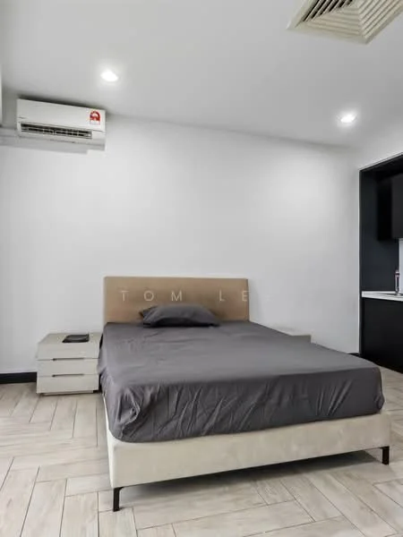 Bedroom features: queen-size bed with grey bedding, upholstered headboard, nightstand with drawer, wall-mounted air conditioning unit, recessed ceiling lights, light-colored tiled flooring, white painted walls, black cabinetry visible in background; style: modern.