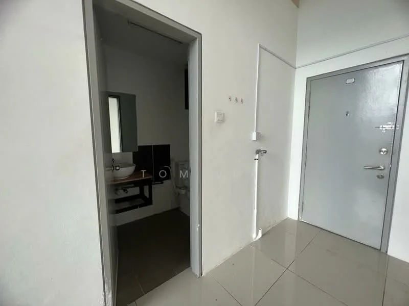 Room features: white painted walls, grey tiled flooring, doorway leading to bathroom, doorway leading to exterior, small window, light switch, plumbing fixtures visible, toilet visible.