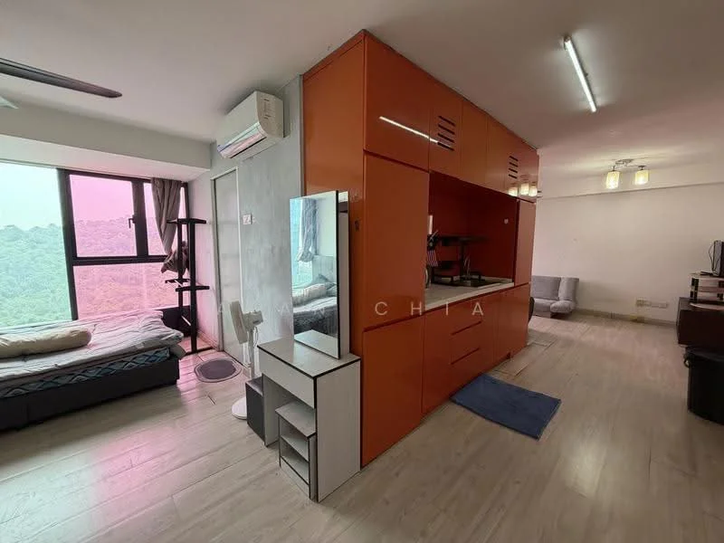 Room features: orange cabinetry, built-in kitchen unit, single-bowl stainless-steel sink, chrome pull-down faucet, refrigerator, wall-mounted split AC, light wood flooring, large window with city view, bed with bedding, mirror, blue bath mat, two grey chairs, ceiling lights; style: modern; view: city.