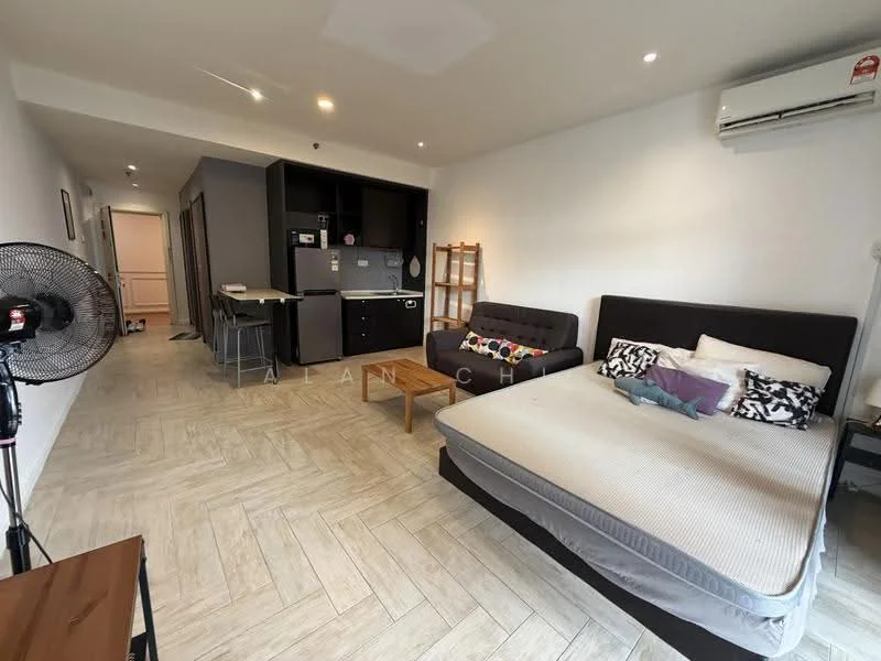 Living features: laminate flooring, white painted walls, recessed downlights, wall-mounted split AC, sofa bed in dark fabric, wooden coffee table, open shelving unit, kitchenette with black cabinetry, stainless-steel fridge, built-in oven, countertop with bar stools; style: modern.