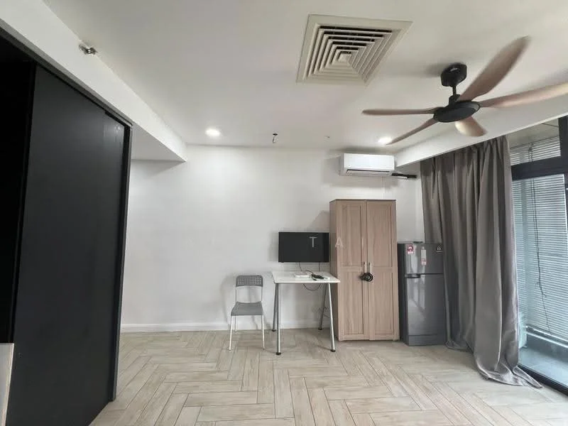 Living features: light wood herringbone flooring, white painted walls, exposed ceiling with air conditioning vent, 5-blade ceiling fan, large window with sheer curtains, computer desk with chair, wooden cabinet, stainless-steel fridge, wall-mounted air conditioning unit; style: modern.