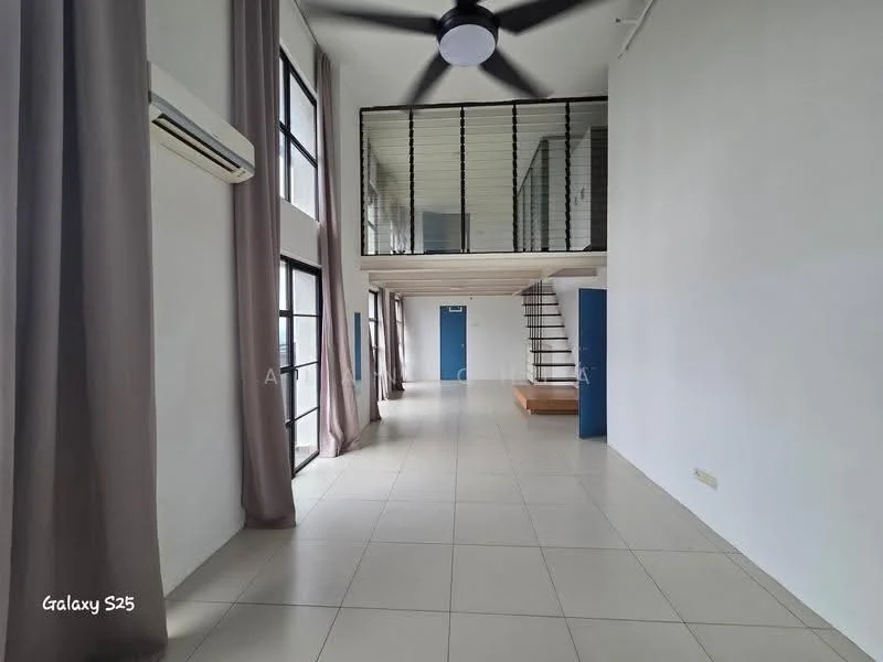 Room features: white painted walls, large floor-to-ceiling windows, grey curtains, light-colored tiled flooring, 5-blade ceiling fan, wall-mounted split AC, open staircase, wooden landing area, high ceiling, minimalist design; style: modern.