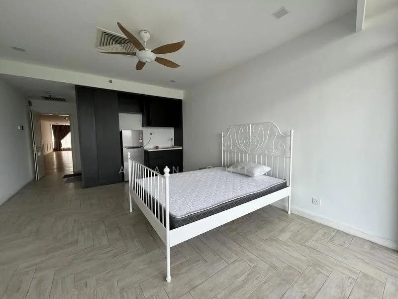 Bedroom features: white metal bed frame, mattress on bed, ceiling fan with 5 blades, light wood flooring, white painted walls, window with natural light, open layout to kitchen, no bedside tables; style: modern. Kitchen features: black cabinetry, stainless-steel fridge, kitchen countertop, open layout to living space; style: modern.