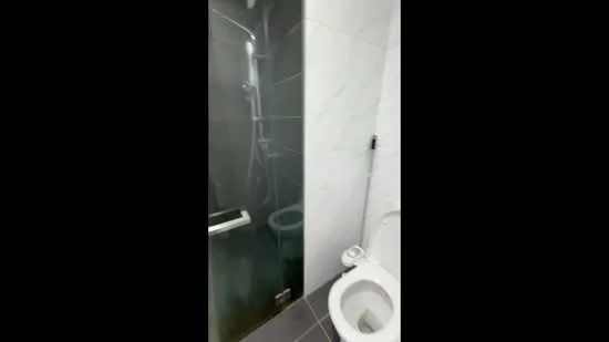 Bathroom features: walk-in shower with glass enclosure, rain shower head, handheld shower, white toilet, grey tile flooring, marble tile wall cladding, chrome faucet, glass shower screen; style: modern.