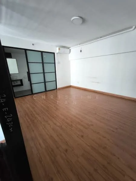 Room features: laminate flooring, white painted walls, ceiling with recessed lighting, wall-mounted split AC, glass sliding door, open layout, natural light from windows, no visible furniture; style: modern.
