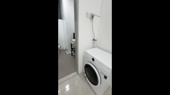 Laundry features: front-load washing machine, white cabinetry, grey tiled flooring, white painted walls, wall-mounted faucet, power outlet, sliding door to adjacent room; style: modern.