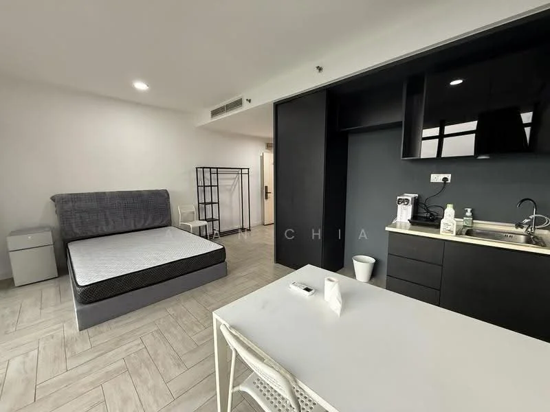 Room features: queen-size bed with mattress, grey upholstered bed frame, white desk with chair, black cabinetry, stainless-steel sink, built-in kitchen cabinet, white walls, light wood-look flooring, recessed ceiling lights, open shelving, small refrigerator, waste bin; style: modern.