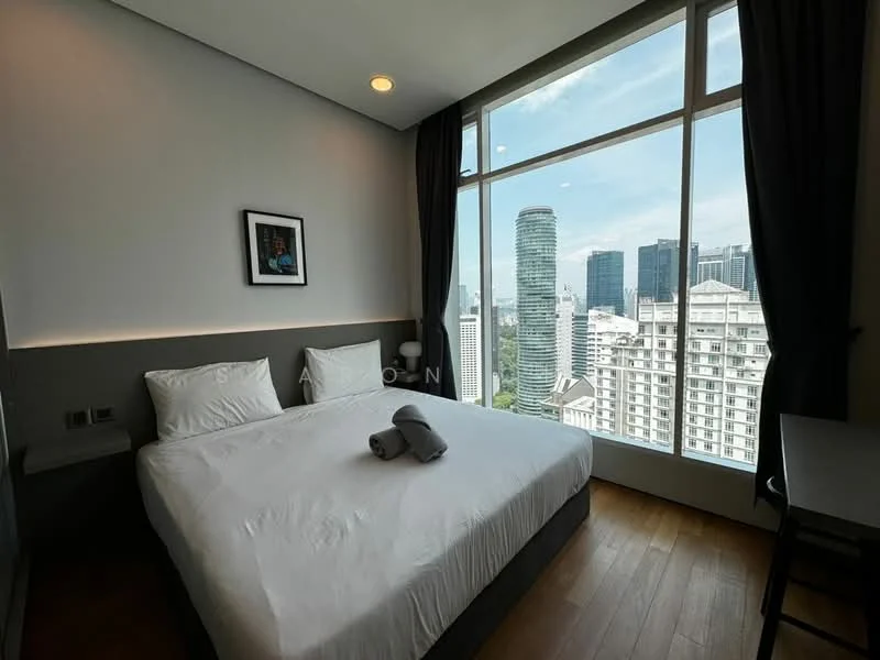 Bedroom features: king-size bed, white bedding, grey upholstered headboard, wooden flooring, floor-to-ceiling windows, city skyline view, blackout curtains, framed artwork, nightstand, table lamp; style: modern; view: city.