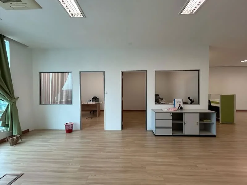 Room features: light wood laminate flooring, white painted walls, large windows with sheer curtains, two doors leading to other rooms, office desk visible in background, office chair visible in background, open space layout, ceiling lights; style: modern; view: city.