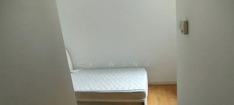Room features: single bed, white mattress, light wood flooring, white painted walls, light switch on wall.