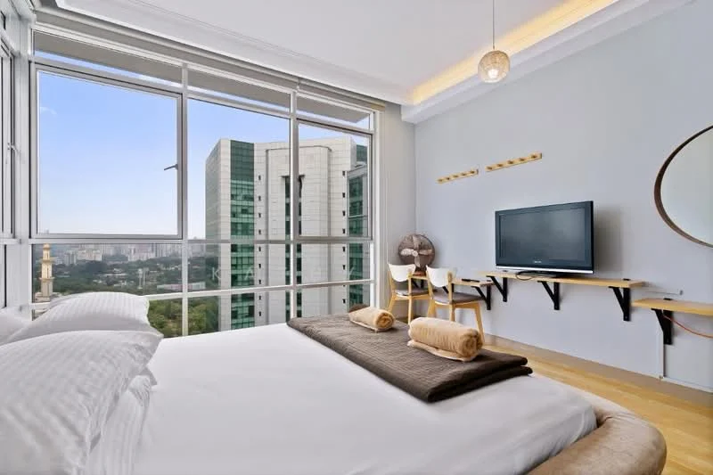 Bedroom features: king-size bed with white bedding, wooden flooring, floor-to-ceiling windows, city skyline view, wall-mounted TV, floating desk with chair, decorative mirror, ceiling light fixture, wall-mounted coat hooks, two rolled towels on bed; style: modern; view: city.